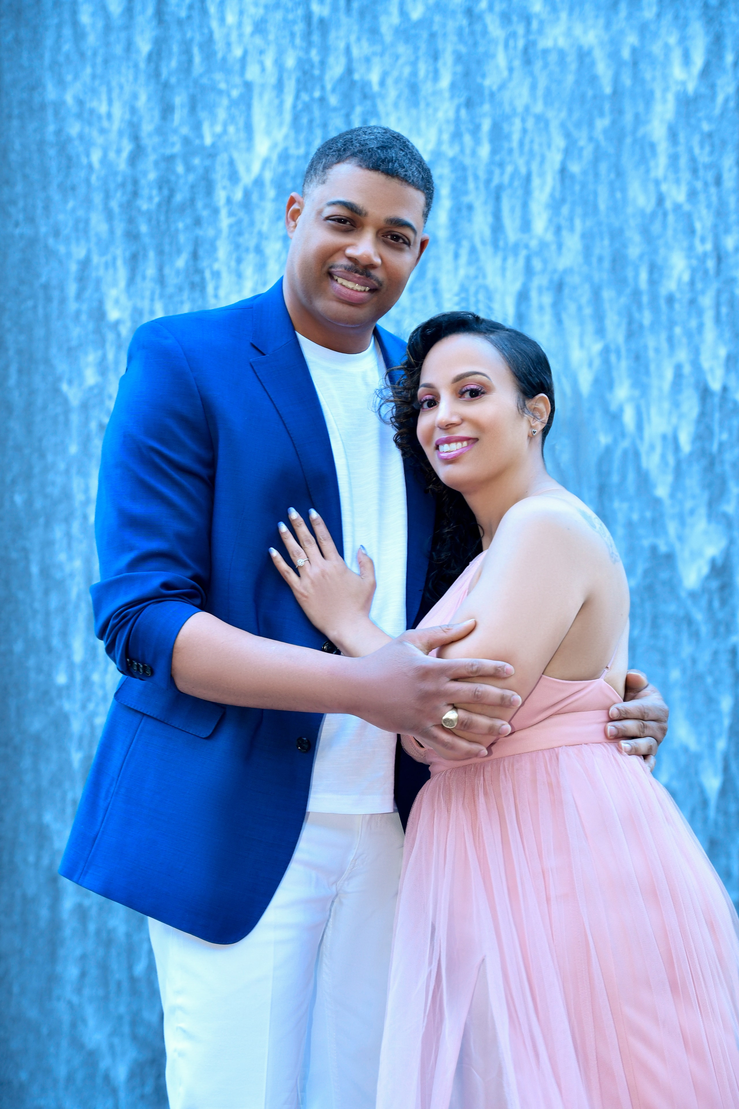 Engaged couple laughing candid portrait golden hour